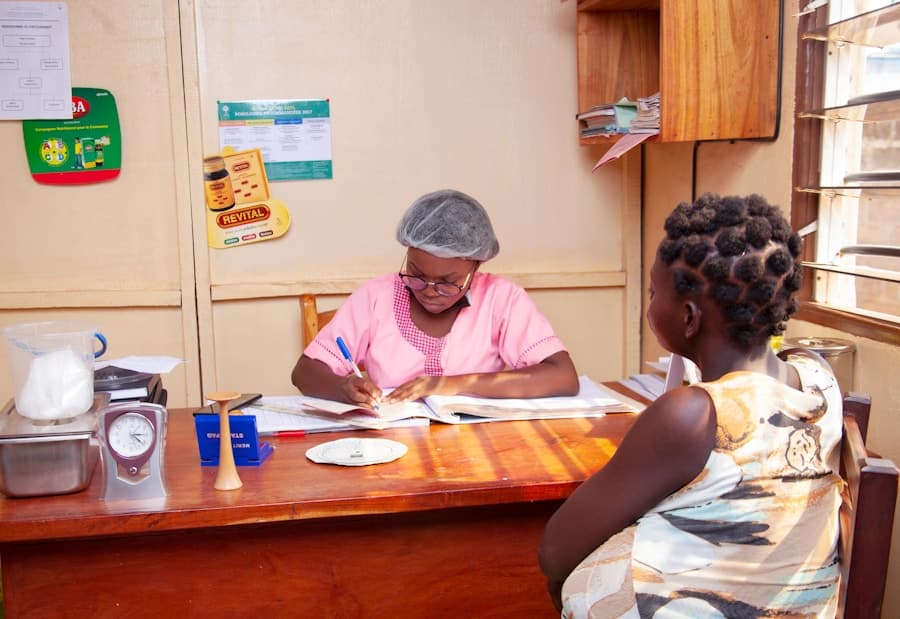 Nurse conducting antenatal consultation with a patient at a primary healthcare centre in Nigeria