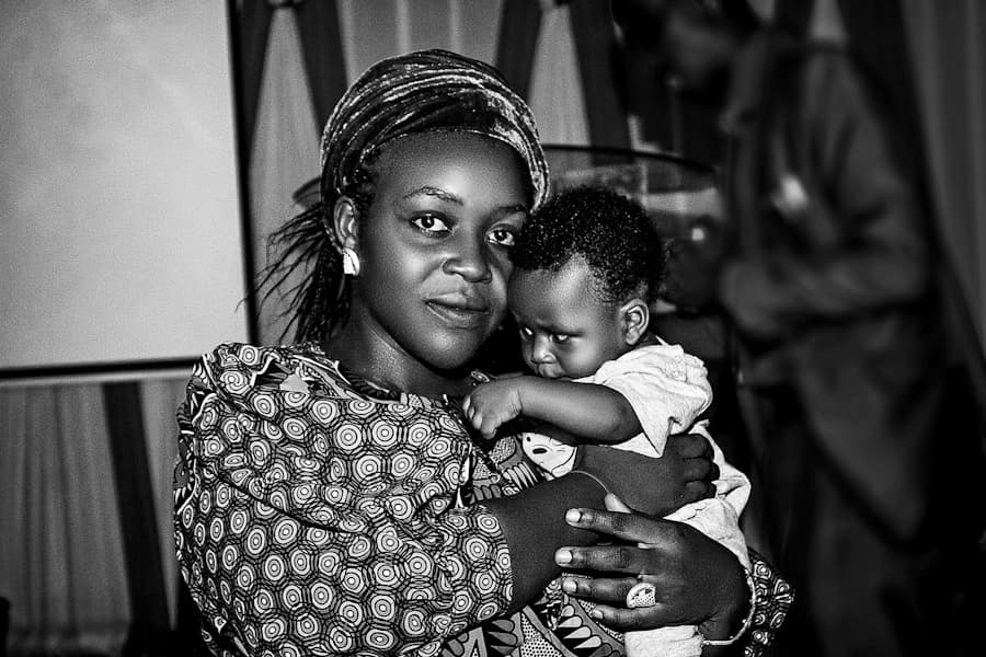 Nigerian mother tenderly holding her newborn baby in a healthcare facility